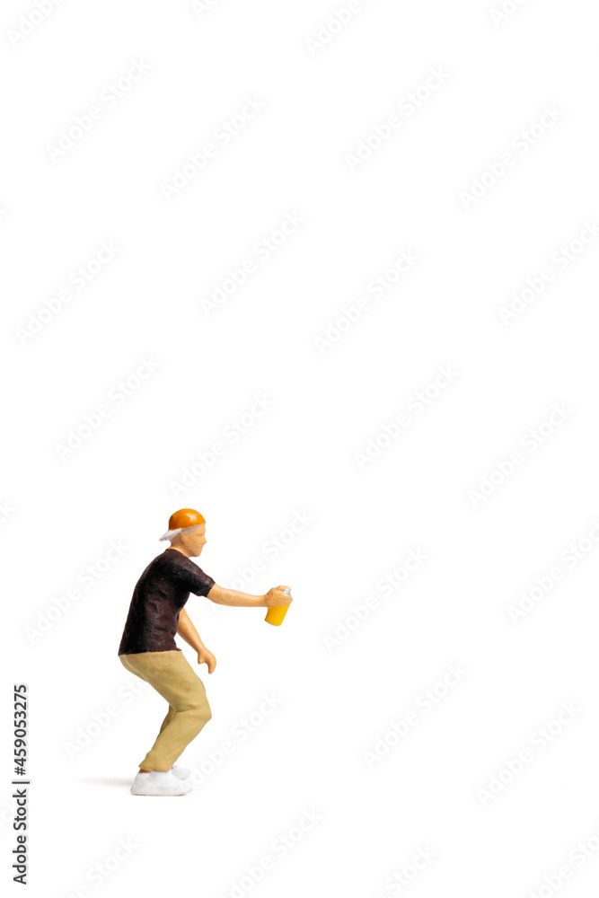 Miniature people Teenager spraying paint from can on white background and space for text