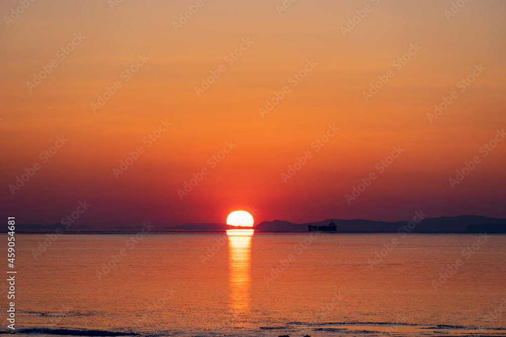 Beautiful sunset over the sea and the silhouette of the ship Beautiful sunset over the sea and the silhouette of the ship