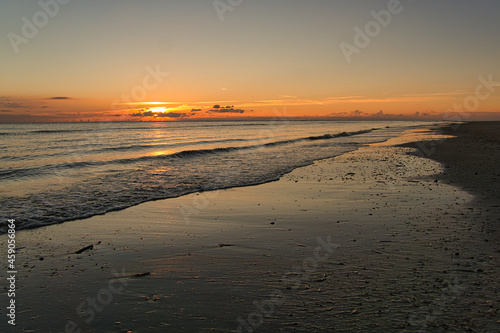 Sunset on the beach of Blåvand in Denmark. Walking in the evening in great light atmosphere