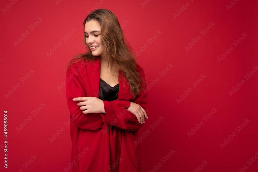 Portrait of young attractive caucasian hipster woman in trendy casual clothes. Sexy carefree female person posing isolated near red wall in studio. Positive model with natural makeup. Empty space Portrait of young attractive caucasian hipster woman in trendy casual clothes. Sexy carefree female person posing isolated near red wall in studio. Positive model with natural makeup. Empty space
