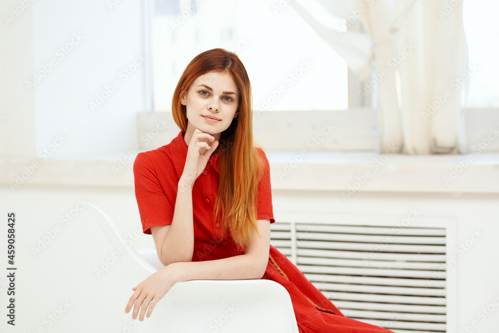 woman sitting on a chair red dress posing room woman sitting on a chair red dress posing room