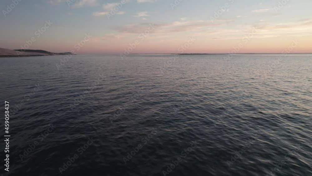 Aerial drone forward view over sea at sunset near Dune of Pilat at Arcachon, France Aerial drone forward view over sea at sunset near Dune of Pilat at Arcachon, France