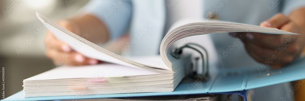 Woman examining information in folder with documents closeup - obrazy, fototapety, plakaty 