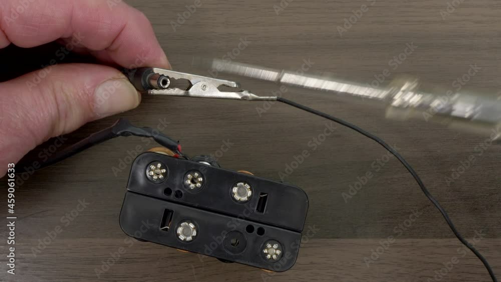 Closeup POV overhead shot of a man’s hands connecting the clip and