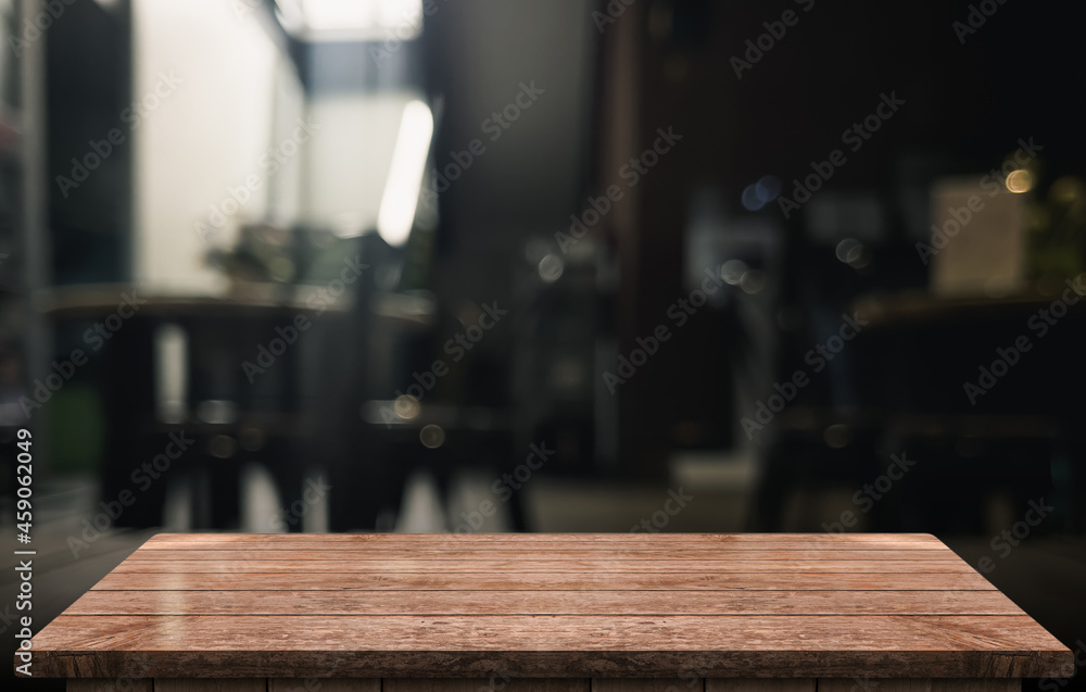 Empty wooden table top with lights bokeh on blur restaurant background. Empty wooden table top with lights bokeh on blur restaurant background.