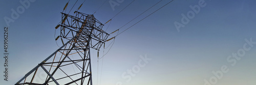 Electric station with wires standing on background of sunset closeup