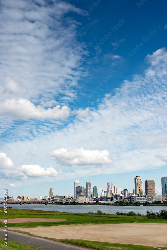 View of office buildings of central Osaka city from Yodogawa river bank