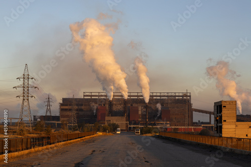 Clouds of smoke and vapor rise out of Steel plant Temirtau at sunrise time in Temirtau, Kazakhstan.