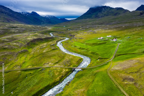 Aerial scenic landscape of Iceland. Remote road and small bridge over blue mountain river. Travel vacation and advanture concept