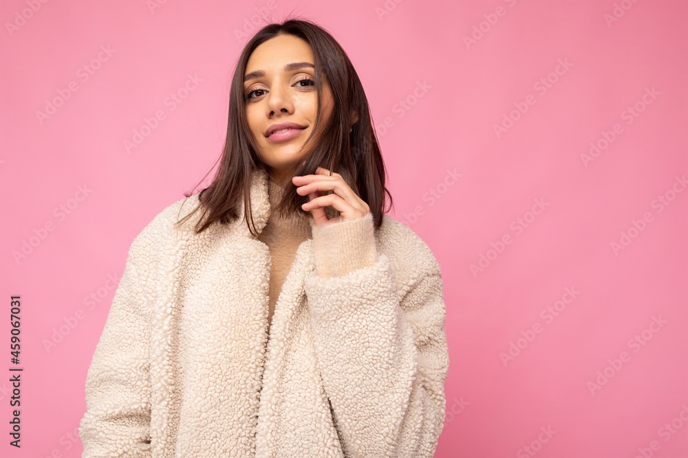 Portrait of attractive self-confident positive happy good-looking stylish young brunette woman wearing autumn beaige warm coat isolated on pink background with free space. Fashion concept Portrait of attractive self-confident positive happy good-looking stylish young brunette woman wearing autumn beaige warm coat isolated on pink background with free space. Fashion concept