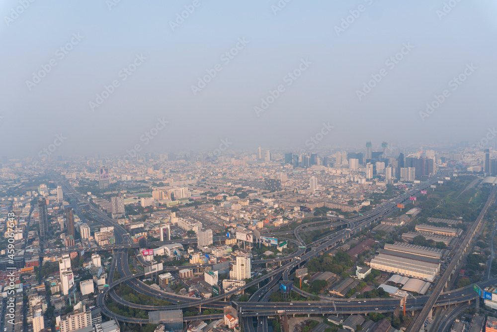 Landscape of the top view Bangkok metropolis Thailand with the dirty clouds air pollution problem. the tower and building with road line in business area