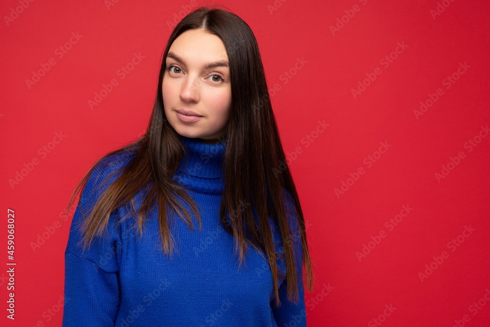 Photo of young pretty beautiful brunette woman with sincere emotions isolated on background wall with copy space wearing casual trendy blue sweater looking at camera