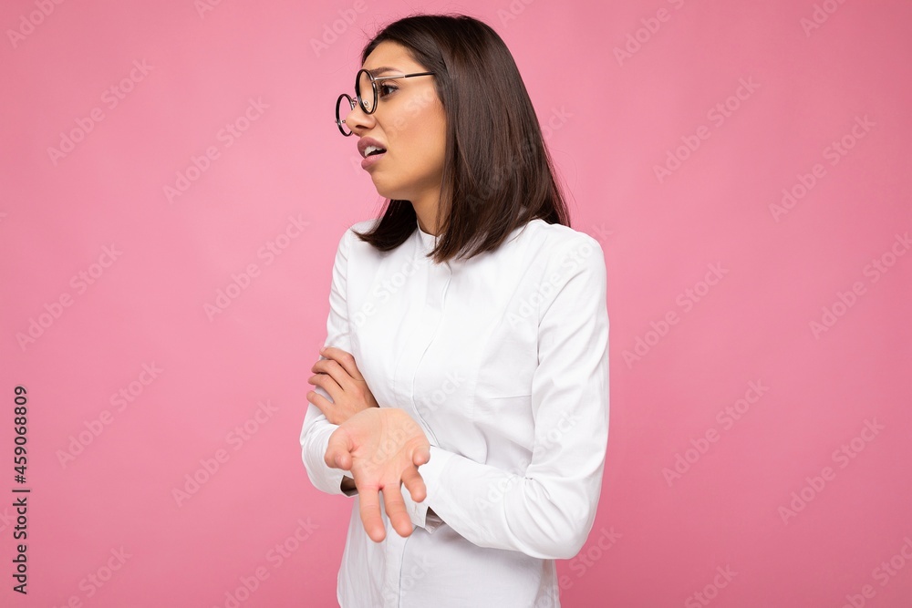 Photo shot of beautiful tired young brunette woman wearing casual clothes and stylish optical glasses isolated over colorful background looking to the side Photo shot of beautiful tired young brunette woman wearing casual clothes and stylish optical glasses isolated over colorful background looking to the side