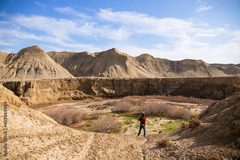 A photographer takes pictures of a canyon near the town of Sangachaly. Azerbaijan.