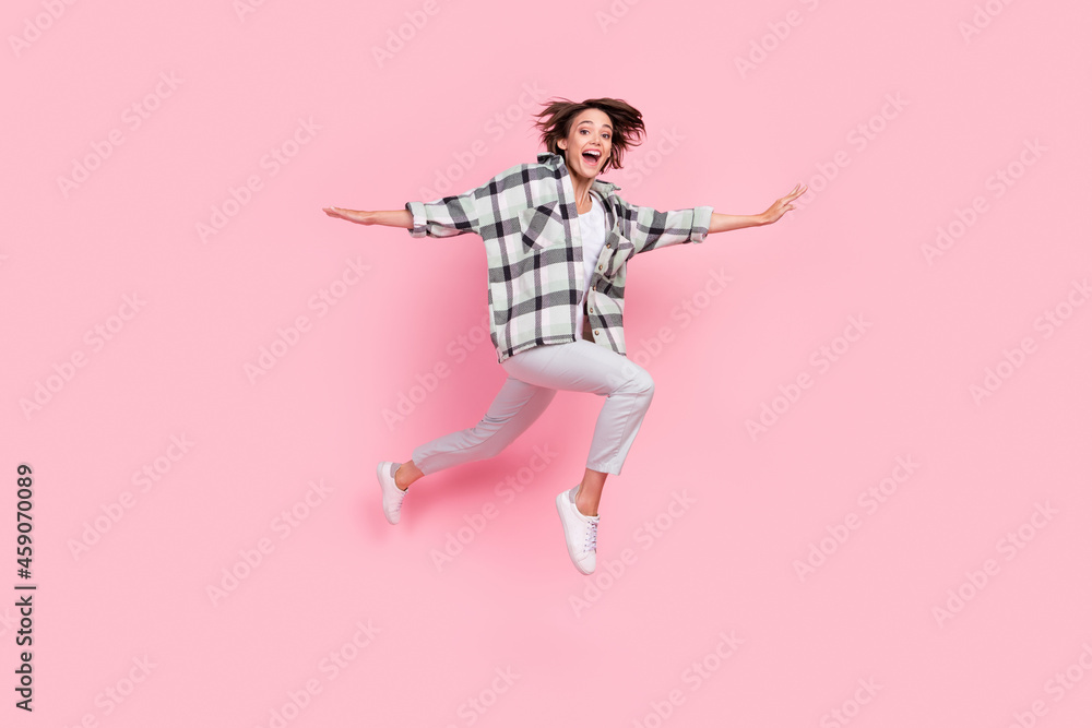Full body photo of funny millennial brunette lady jump wear shirt trousers shoes isolated on pink background Full body photo of funny millennial brunette lady jump wear shirt trousers shoes isolated on pink background