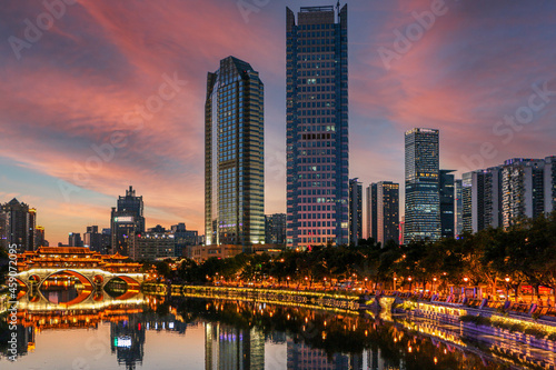 Fiery red sky above the famous Anshun Bridge, the Jinjiang River and modern skyscrapers in Chengdu, Sichuan, during a very hot summer evening photo