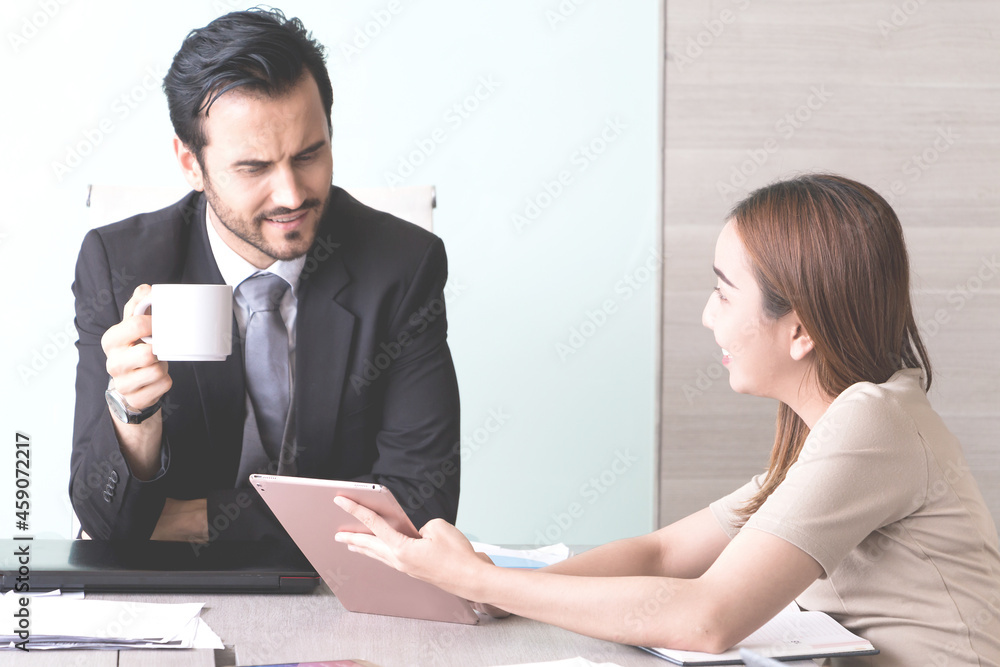 Portrait of manager and his team at meeting room in office.
