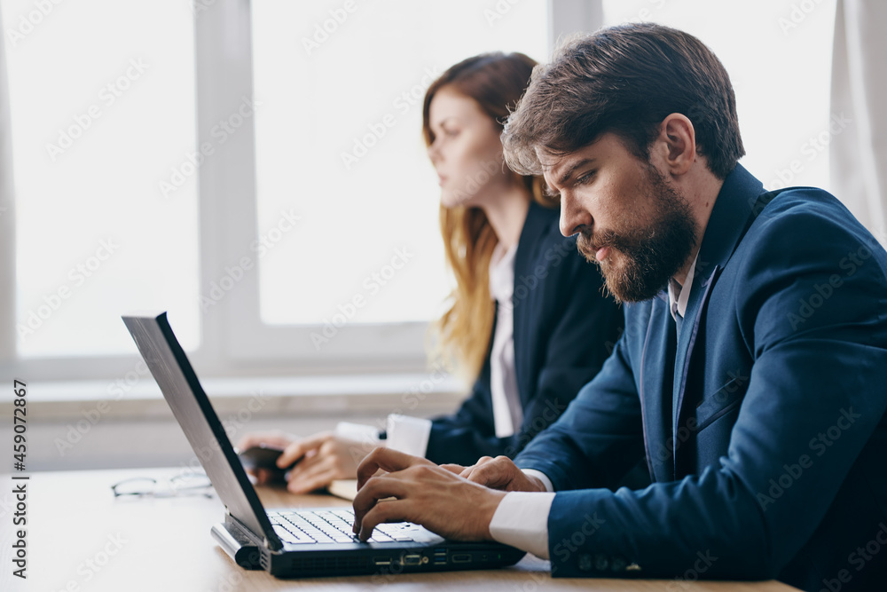 managers sitting in front of a laptop teamwork internet officials managers sitting in front of a laptop teamwork internet officials