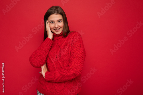 Photo of beautiful positive smiling adult woman wearing stylish clothes standing isolated on colorful background with copy space looking at camera © Ivan Traimak