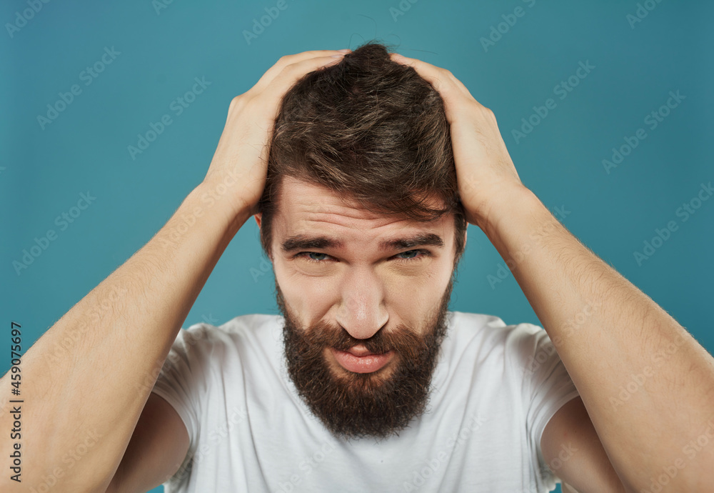 Man in a white t-shirt irritated facial expression Studio