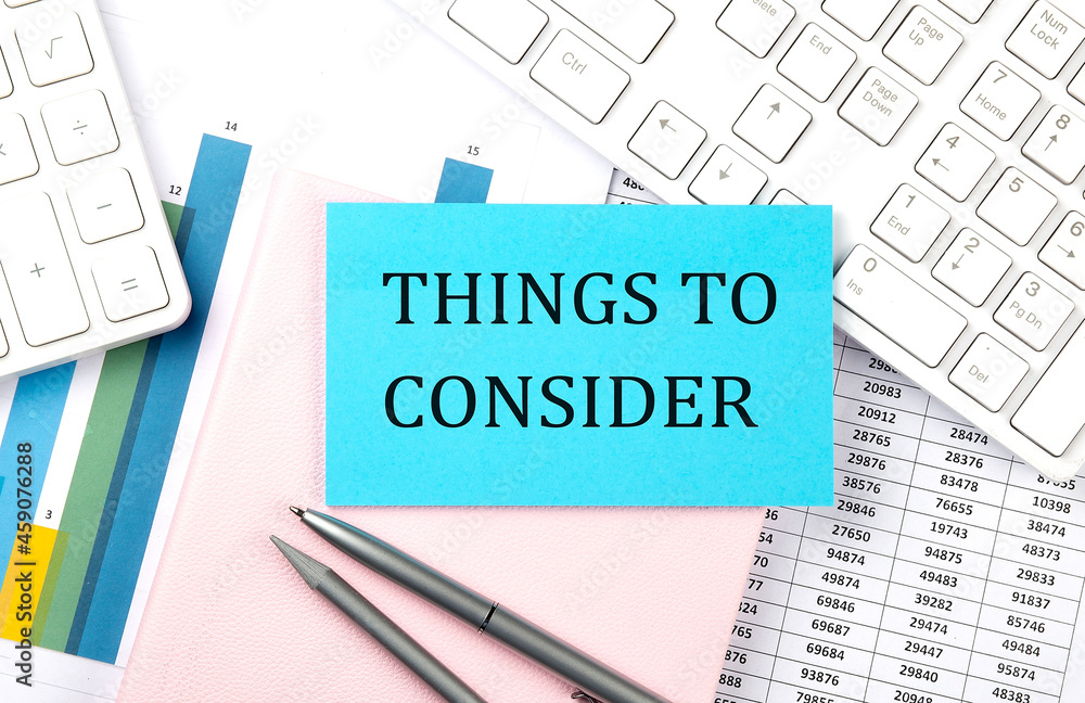 THINGS TO CONSIDER text on blue sticker on chart with calculator and keyboard,Business concept THINGS TO CONSIDER text on blue sticker on chart with calculator and keyboard,Business concept
