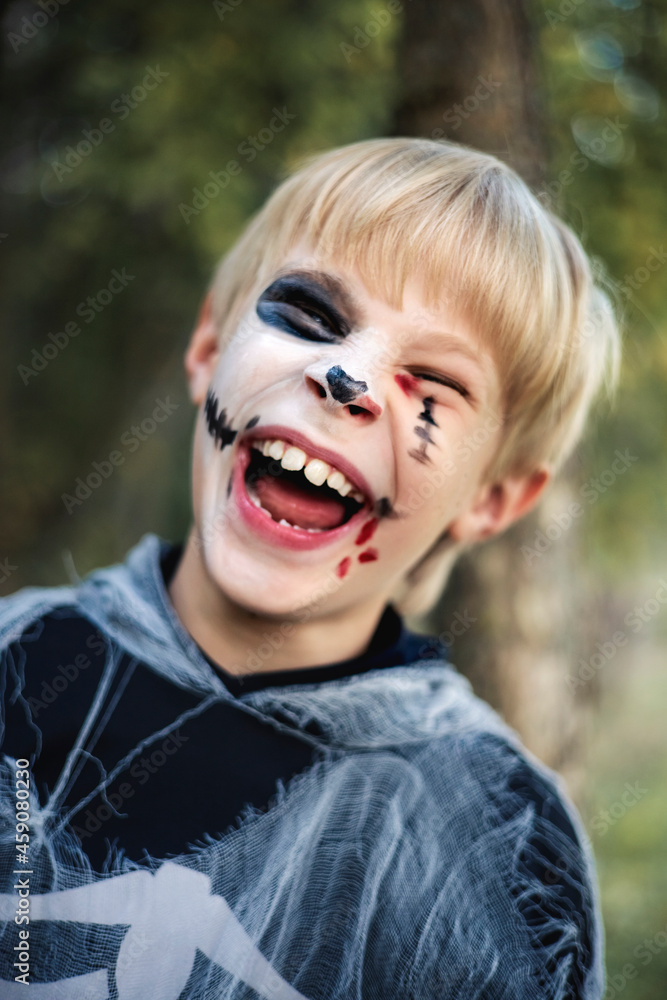 A funny boy in a skeleton costume for Halloween A funny boy in a skeleton costume for Halloween