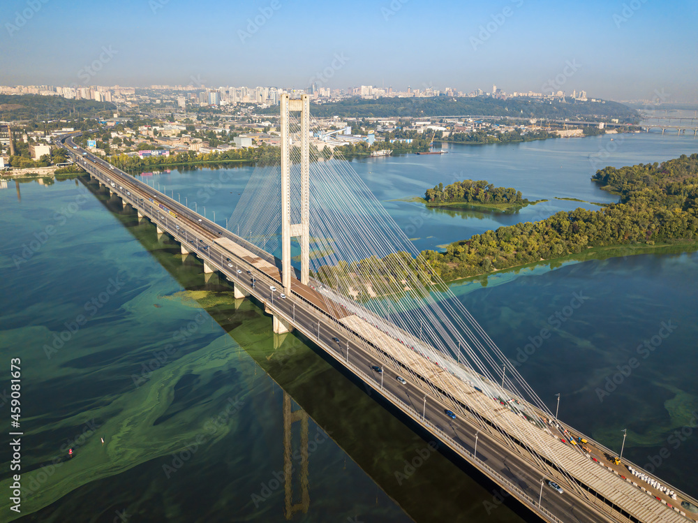 South bridge in Kiev. Algae bloom in the water of the Dnieper River. Aerial drone view.