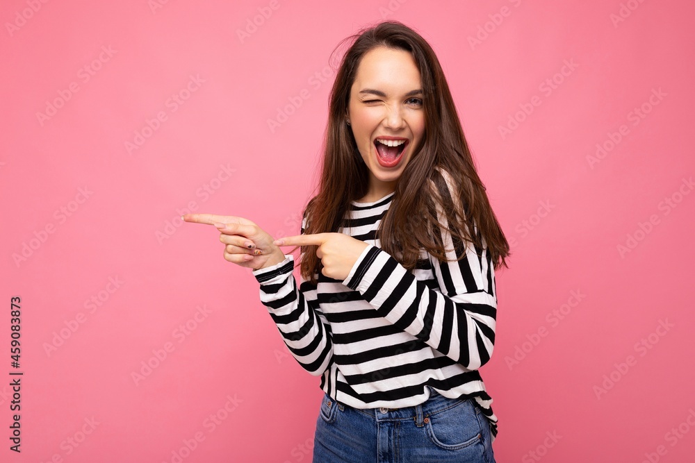 Portrait of beautiful fascinating emotional positive joyful happpy female promoter pointing to the side at copy space for advertising wearing hipster outfit isolated over background wall with empty Portrait of beautiful fascinating emotional positive joyful happpy female promoter pointing to the side at copy space for advertising wearing hipster outfit isolated over background wall with empty
