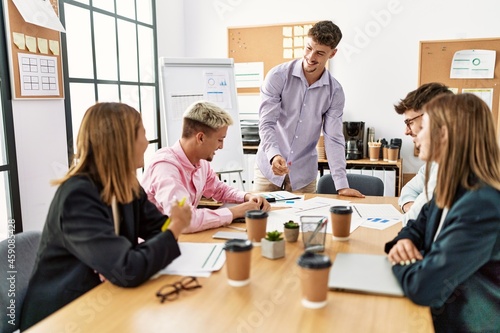 Group of business workers listening hispanic boss man conference at the office.