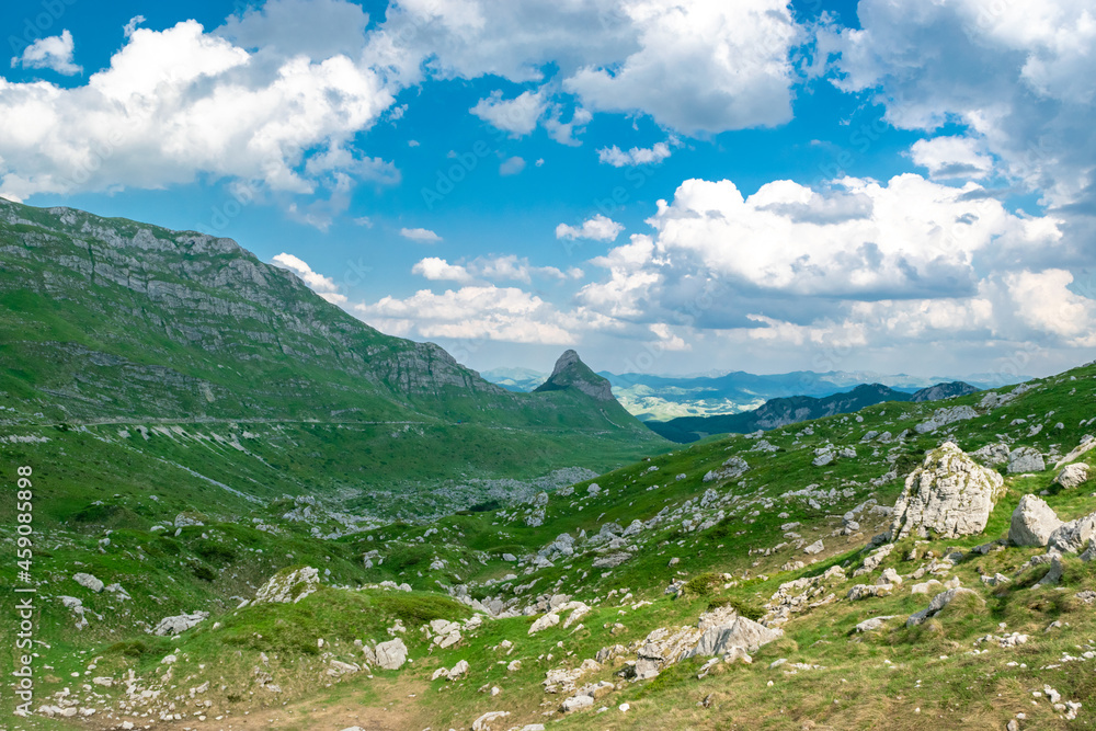 Fototapeta premium Mountains peaks of the Durmitor National Park, along which picturesque high-mountain tourist road of northern Montenegro passes. UNESCO World Heritage site. Beautiful summer cloudy landscape.