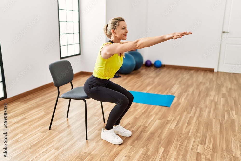 Young blonde girl smiling happy training at sport center. Young blonde girl smiling happy training at sport center.
