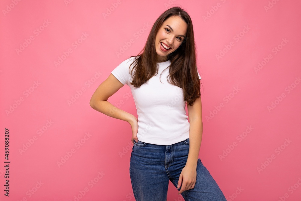 Portrait of positive cheerful fashionable woman in casual t-shirt for mock up isolated on pink background with copy space Portrait of positive cheerful fashionable woman in casual t-shirt for mock up isolated on pink background with copy space