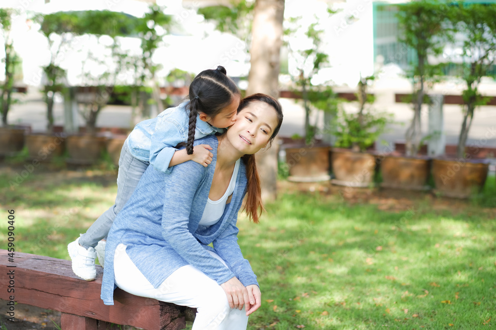 Happy asian family single mom and small daughter in the Park Happy asian family single mom and small daughter in the Park