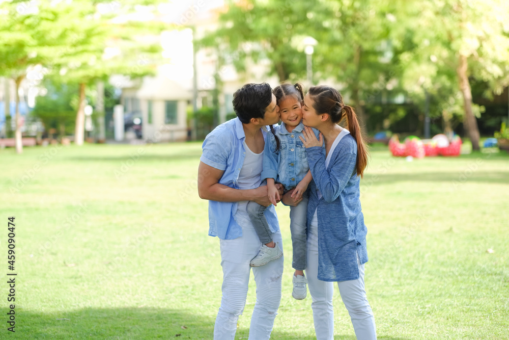 Happy asian family together with daughter in park Happy asian family together with daughter in park