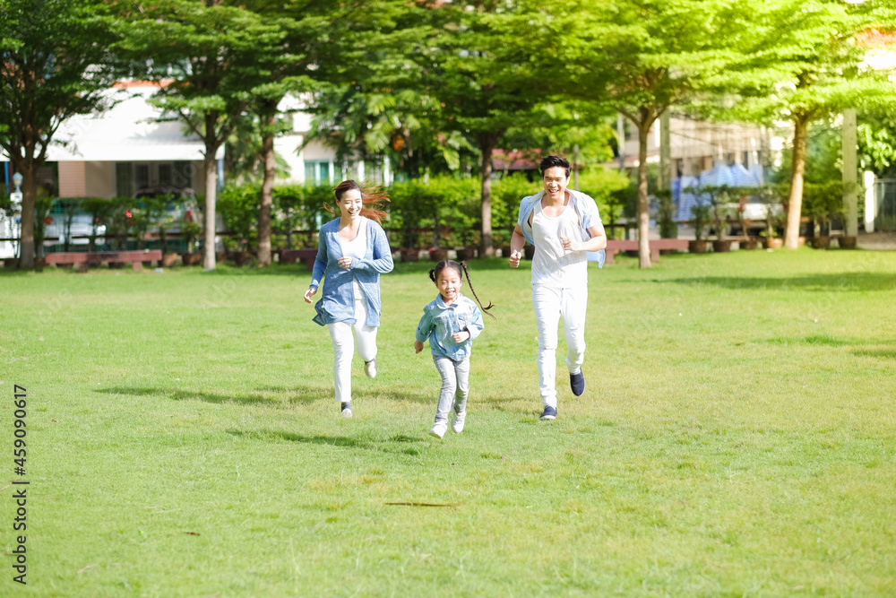 Happy asian family together with daughter in park Happy asian family together with daughter in park