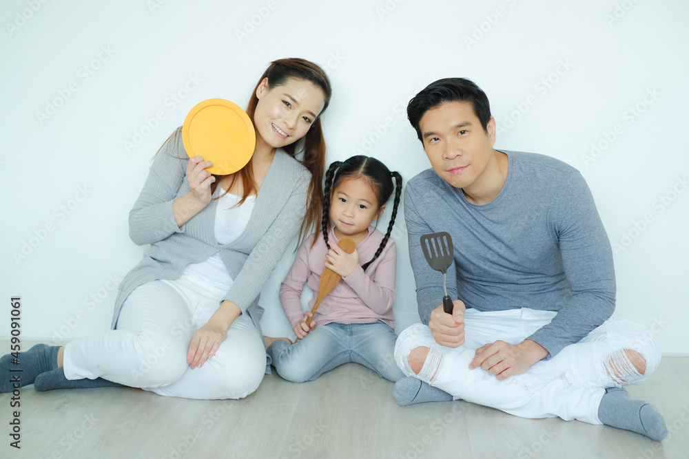 Happy asia family with daughter playing cooking and toys together Happy asia family with daughter playing cooking and toys together