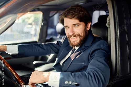businessmen in a suit in a car a trip to work success service rich