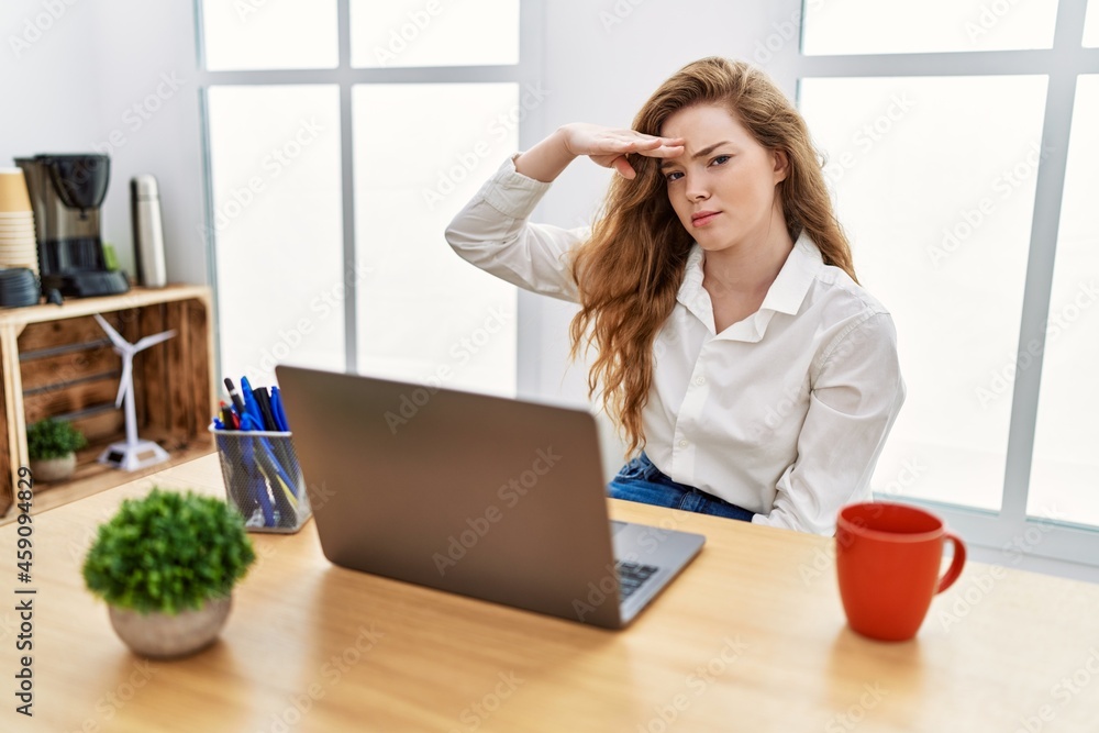 Young caucasian woman working at the office using computer laptop worried and stressed about a problem with hand on forehead, nervous and anxious for crisis Young caucasian woman working at the office using computer laptop worried and stressed about a problem with hand on forehead, nervous and anxious for crisis