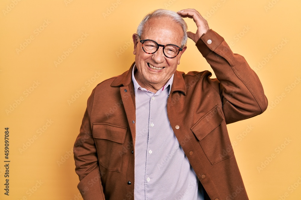 Senior man with grey hair wearing casual jacket and glasses confuse and wonder about question. uncertain with doubt, thinking with hand on head. pensive concept. Senior man with grey hair wearing casual jacket and glasses confuse and wonder about question. uncertain with doubt, thinking with hand on head. pensive concept.