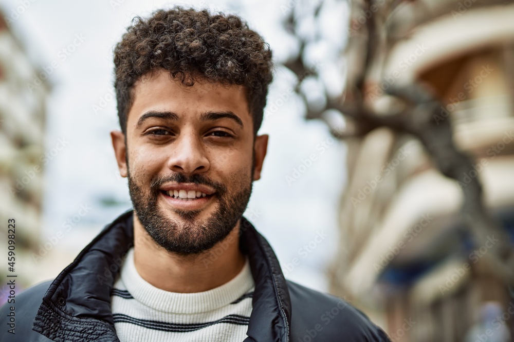 Fototapeta premium Young arab man smiling outdoor at the town
