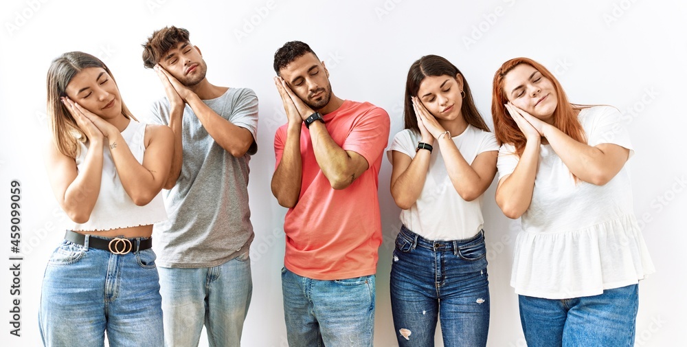 Group of young friends standing together over isolated background sleeping tired dreaming and posing with hands together while smiling with closed eyes. Group of young friends standing together over isolated background sleeping tired dreaming and posing with hands together while smiling with closed eyes.