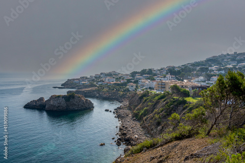 Cala Montgo beach in Catalonia Spain panorama and rainbow