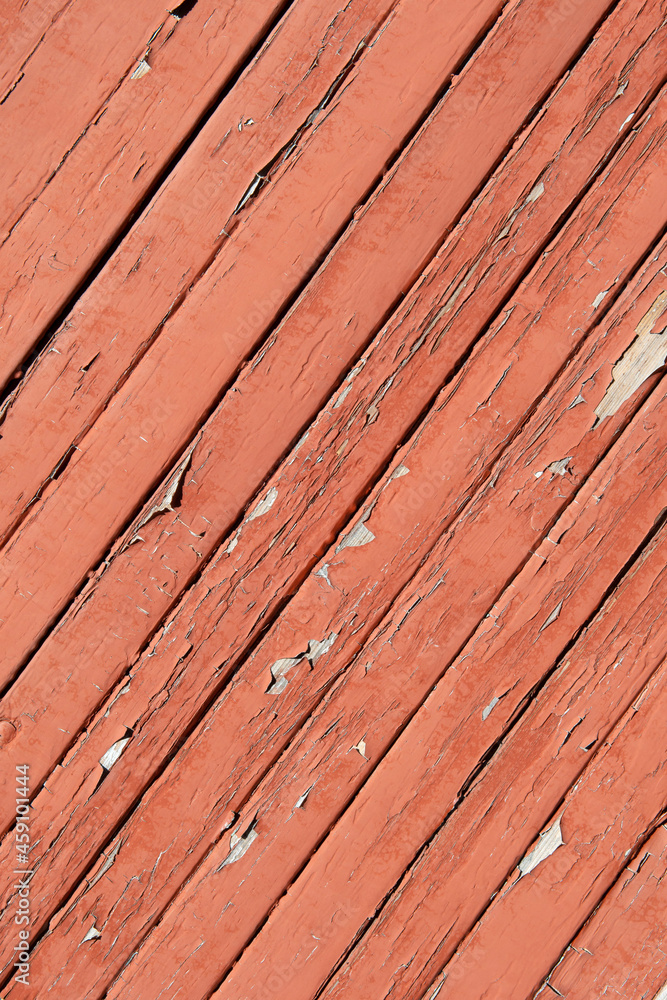 Texture of planks of old wood with peeling red paint Texture of planks of old wood with peeling red paint