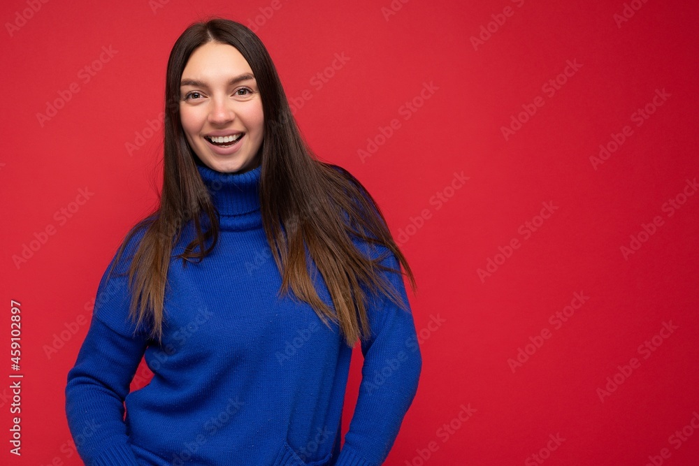 Photo shot of pretty joyful smiling young female person wearing casual trendy outfit standing isolated on colourful background with copy space looking at camera and having fun Photo shot of pretty joyful smiling young female person wearing casual trendy outfit standing isolated on colourful background with copy space looking at camera and having fun