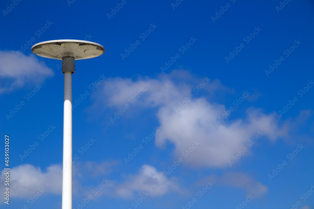 White lamppost in the morning under blue sky White lamppost in the morning under blue sky