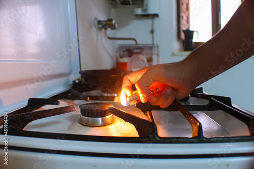 person lighting a fire on a butane stove photo