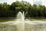 Fountain in the lake. Water pours from the pipes. Urban infrastructure.