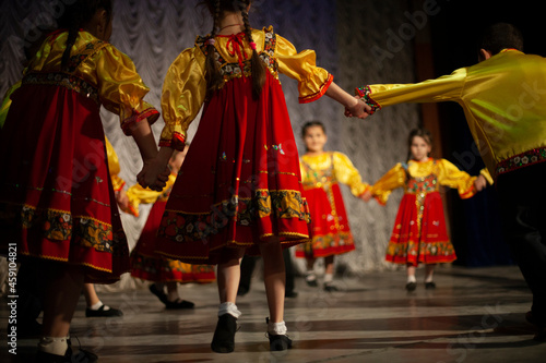 Children in folk costumes lead a round dance.