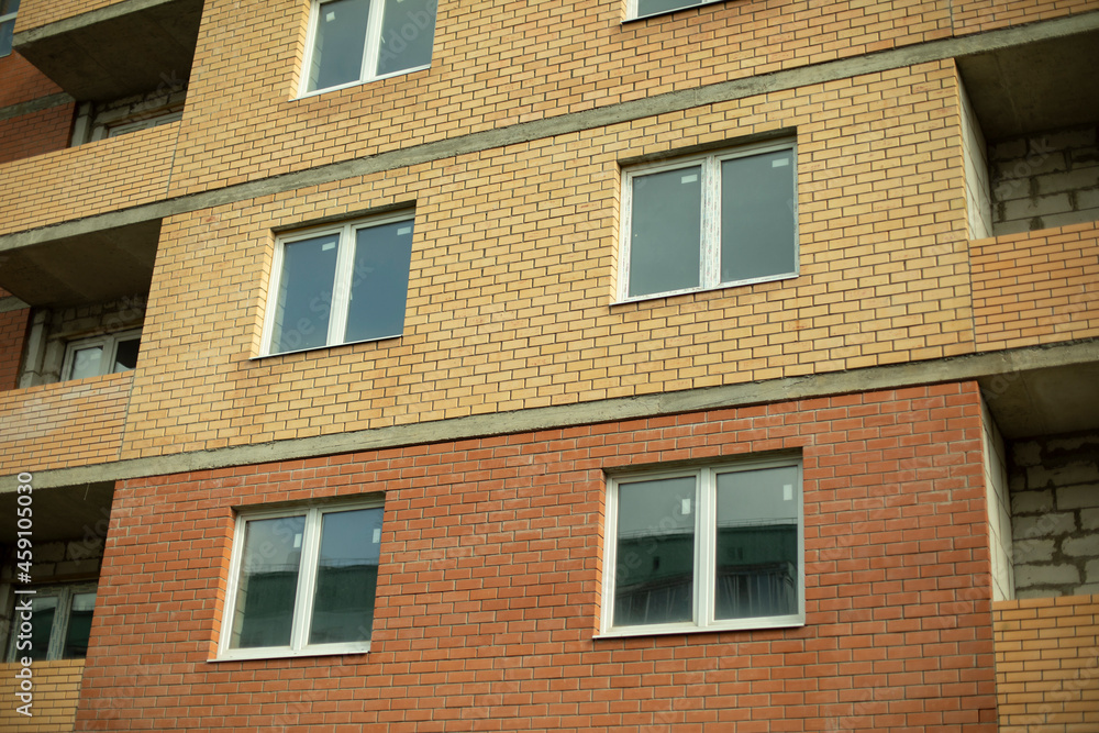 Windows in the new house. Plastic windows are installed in a brick house.