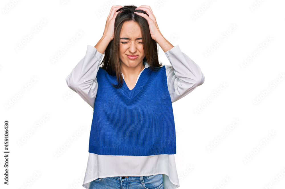 Young hispanic girl wearing casual clothes suffering from headache desperate and stressed because pain and migraine. hands on head. Young hispanic girl wearing casual clothes suffering from headache desperate and stressed because pain and migraine. hands on head.